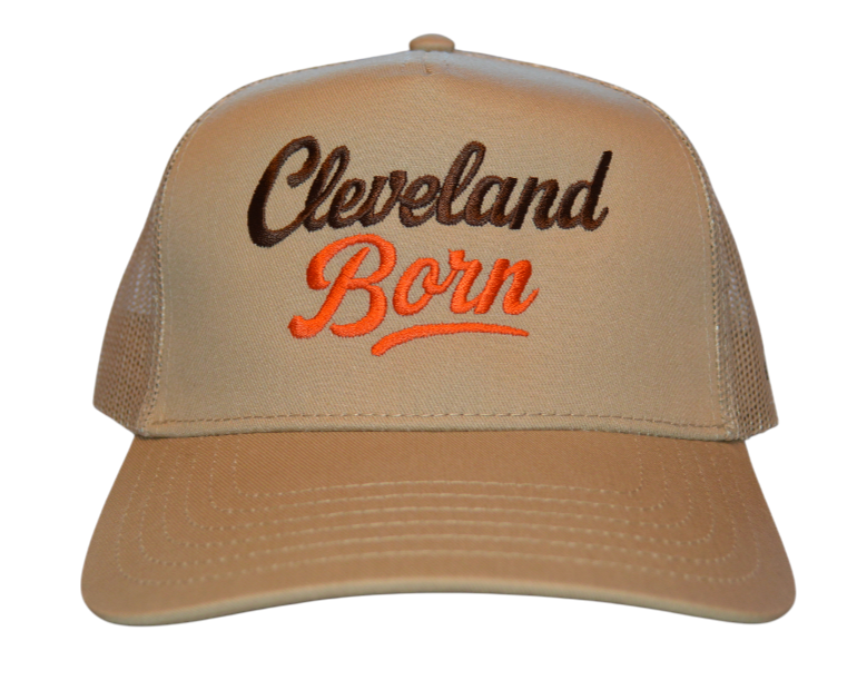 Beige cap with 'Cleveland Born' text in black and orange on a white background